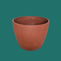 Terracotta-colored planter on a green background from House of Agave.