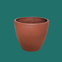 Brown ceramic pot on a green background from House of Agave.