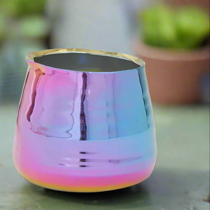 Multicolored metallic cup on a black background