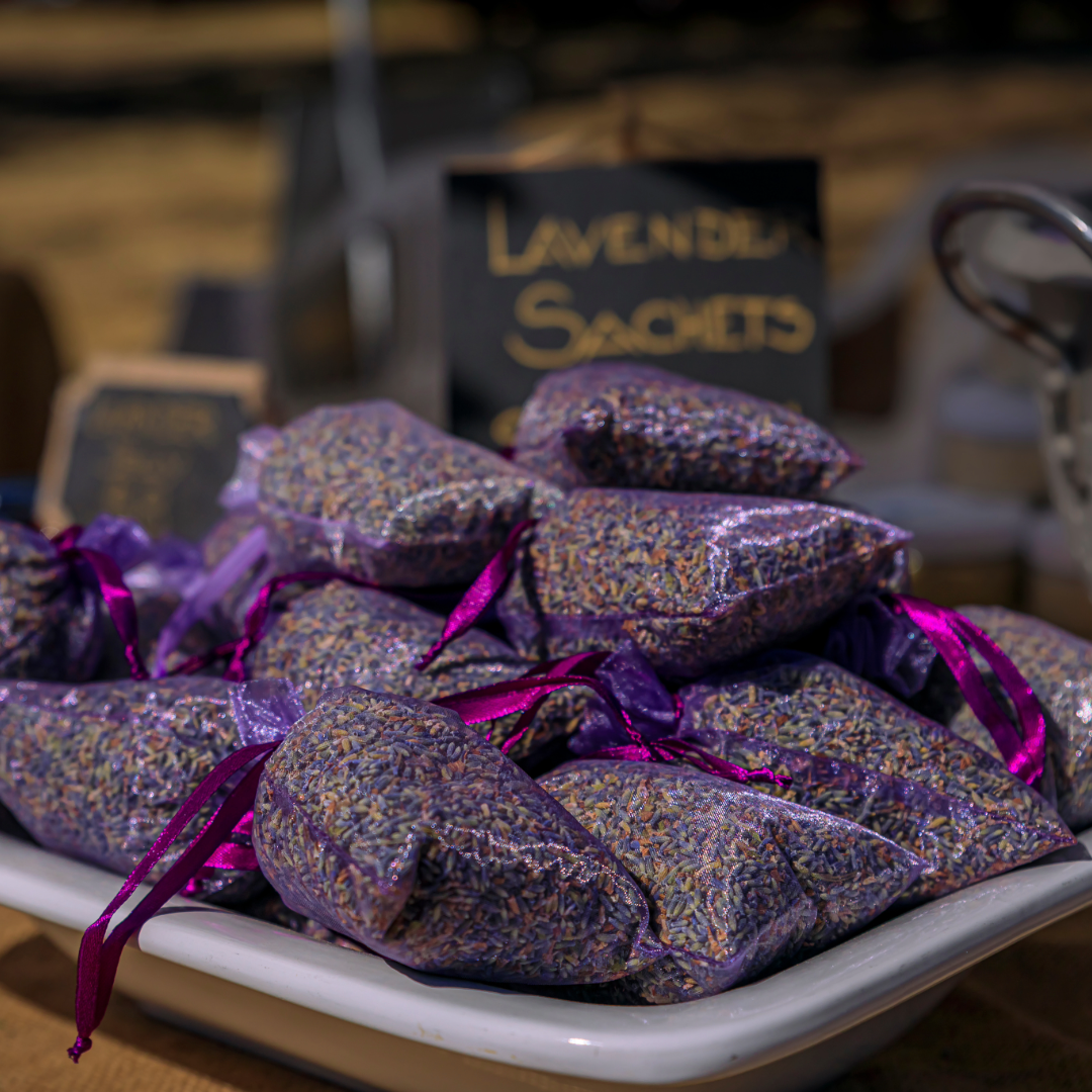 Purple lavender sachets on a white plate with &