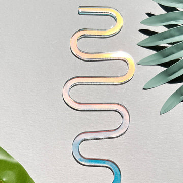Spiral acrylic decoration with gradient colors on a light gray background from House of Agave.