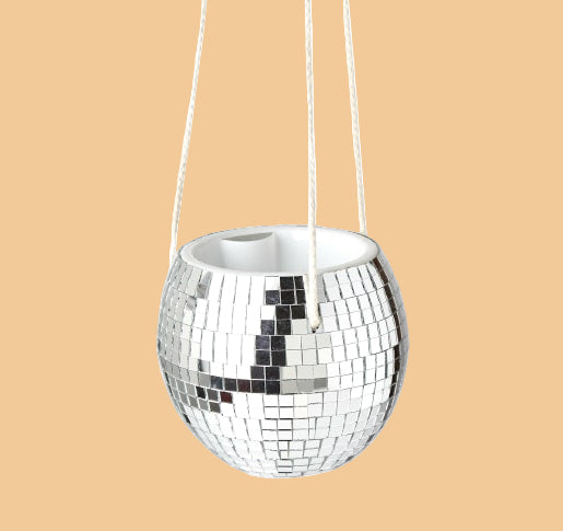 Silver disco ball hanging from a white background